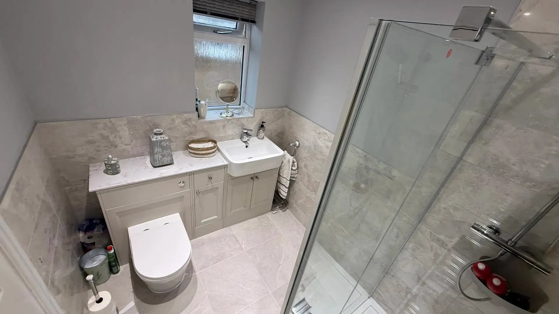 Traditional fitted vanity units and a shower screen in a family bathroom
