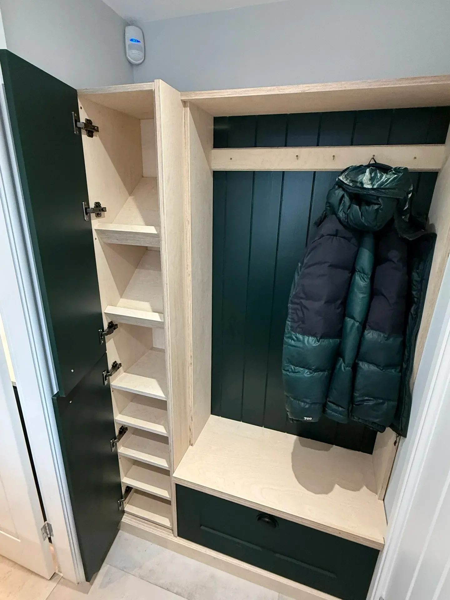 Fitted boot room with open shoe shelving, hanging space and a bench