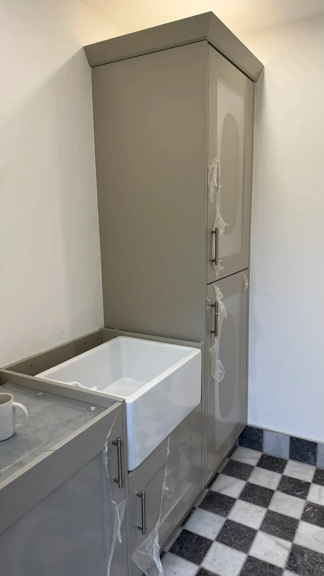 Fitted vanity units and a panelled bath in a part-finished bathroom