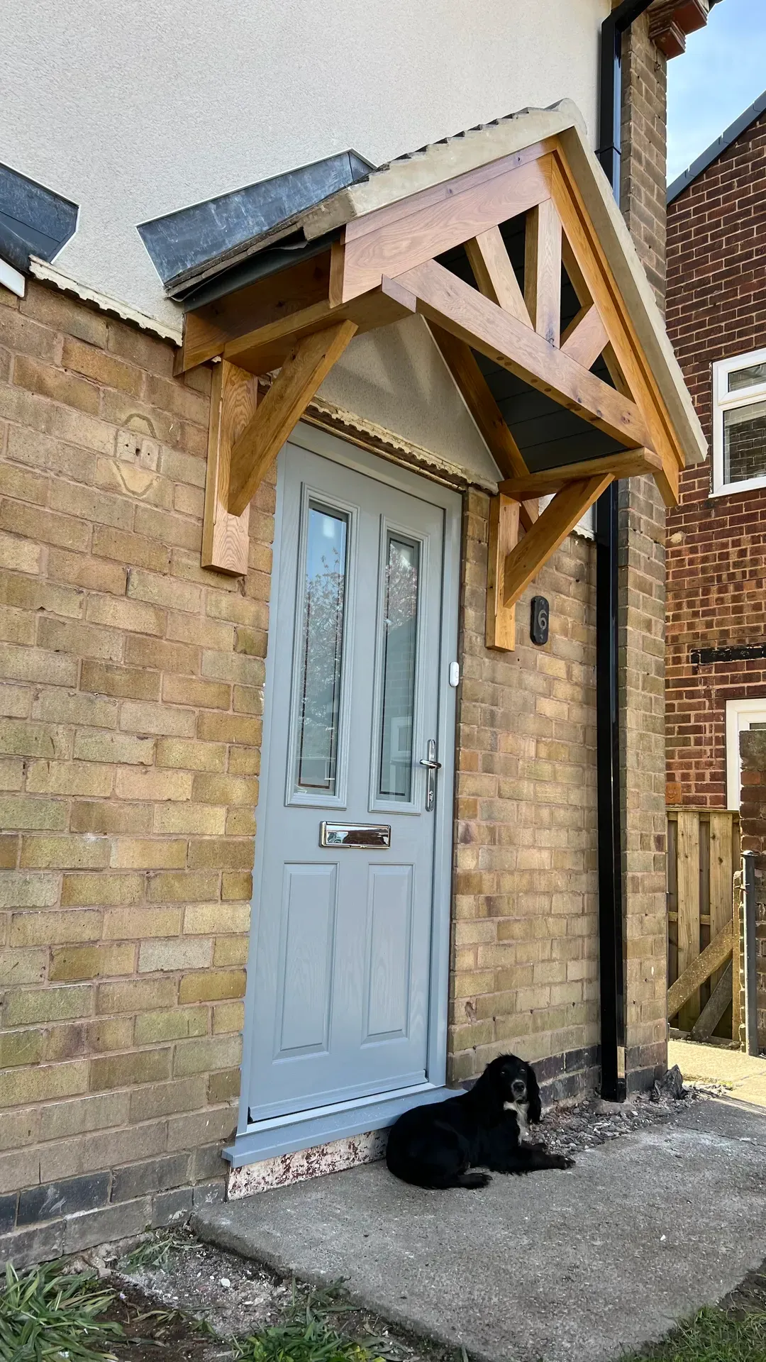 Oak-framed porch canopy over a composite front door