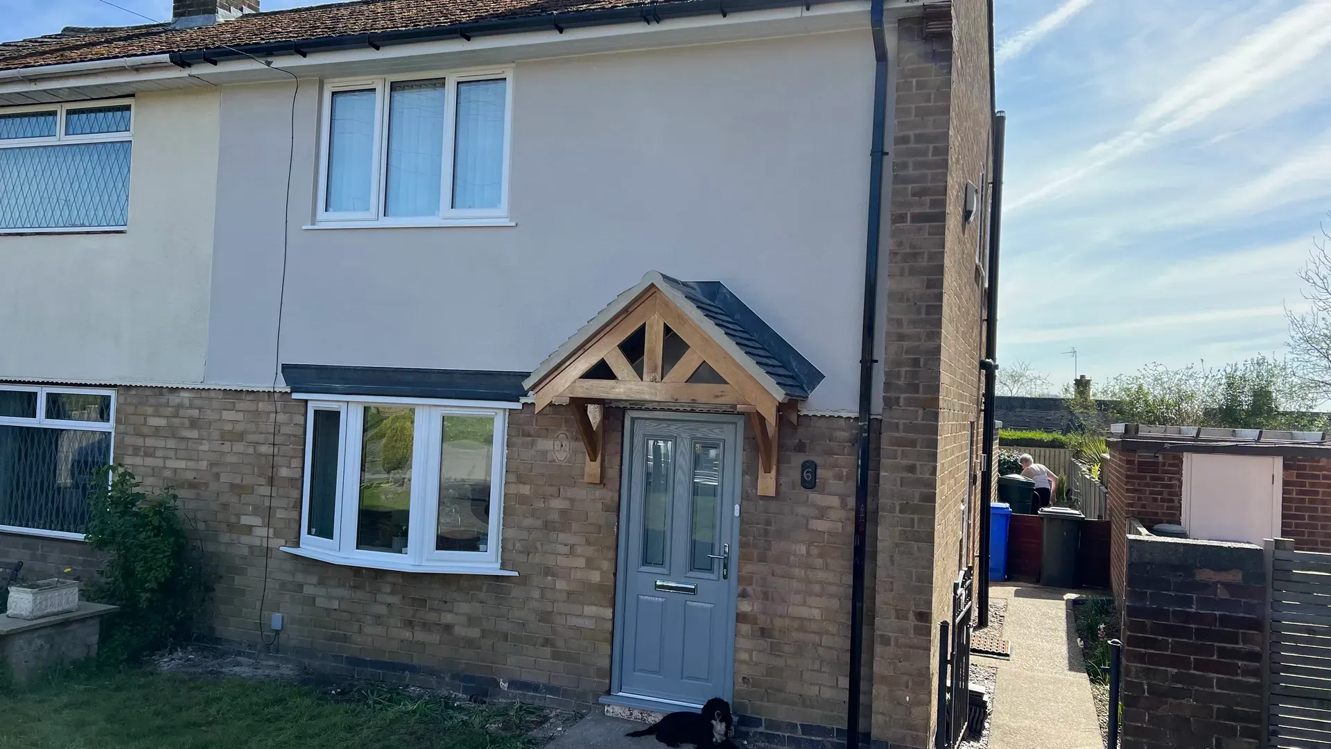 House front with a new oak porch canopy above a composite door