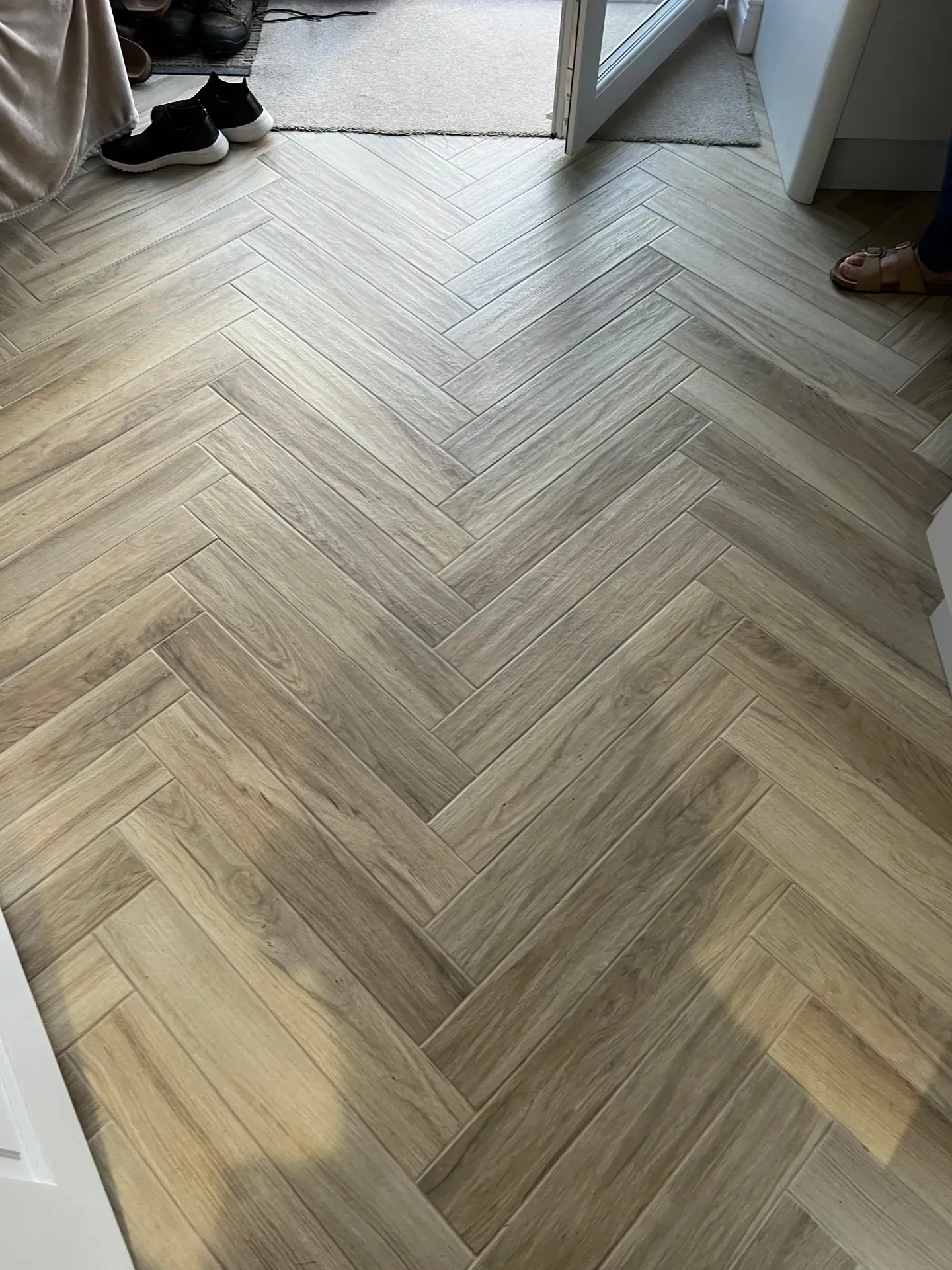 Herringbone wood-effect flooring laid across a room