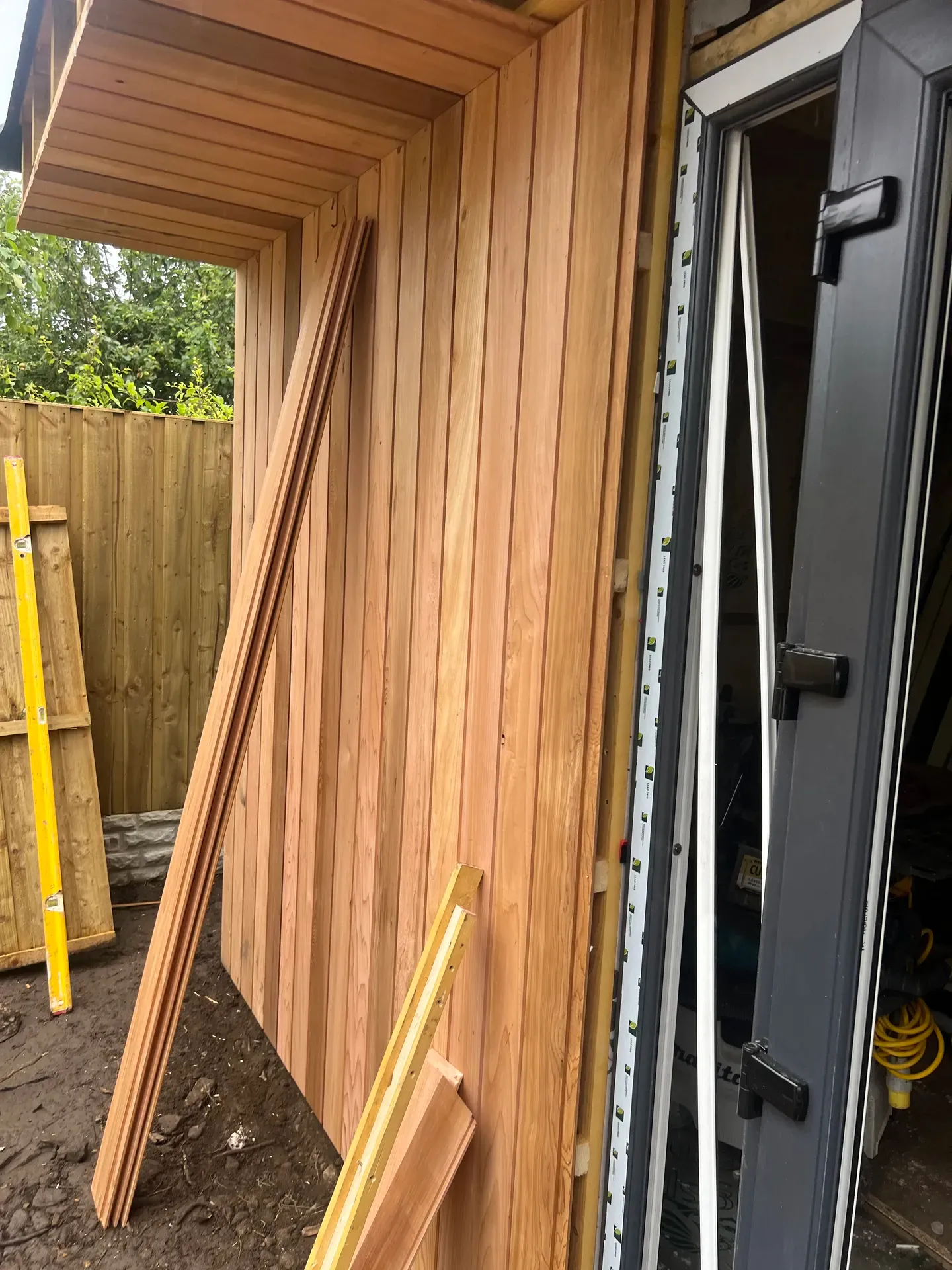 Stack of timber cladding boards ready for an external joinery installation